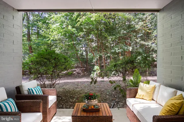 a backyard of a house with outdoor seating