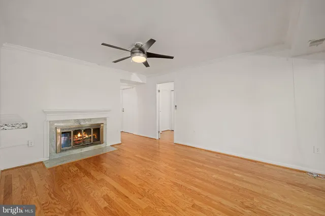 a view of an empty room with a fireplace and a window