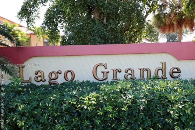 a red sign board with a tree in the background