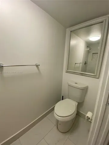 a white toilet sitting next to a bathroom sink