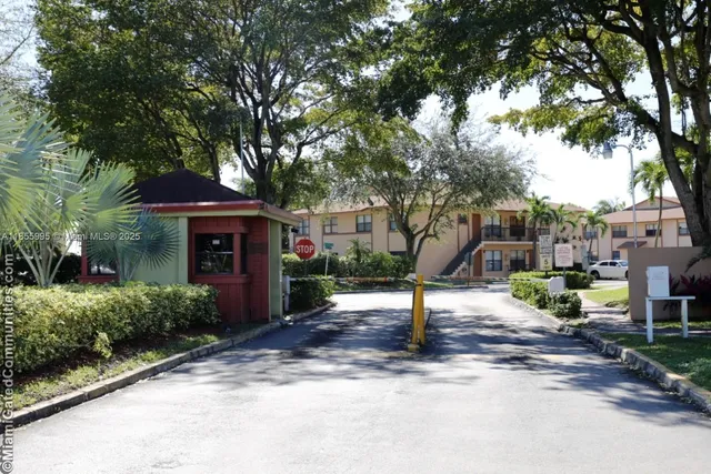 a front view of a house with a yard and tree s