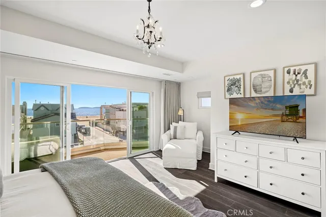 a living room with a floor to ceiling window and stairs