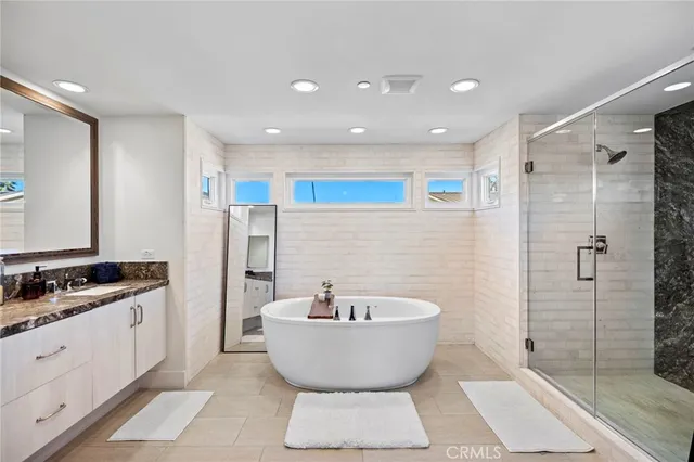 a bathroom with a bathtub and a shower