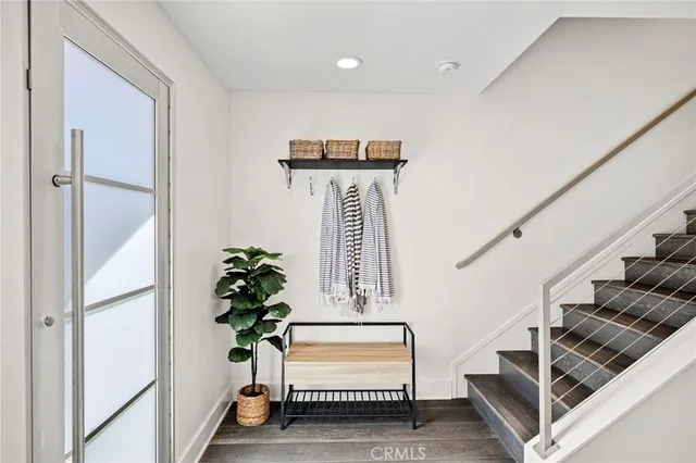 a view of entryway and hall with wooden floor