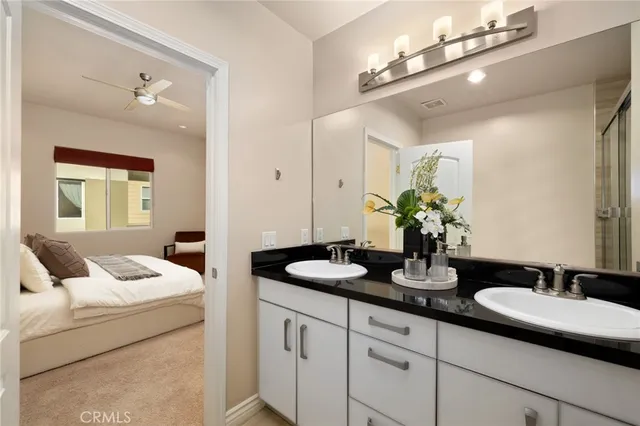 a en suite bathroom with double sink and a mirror
