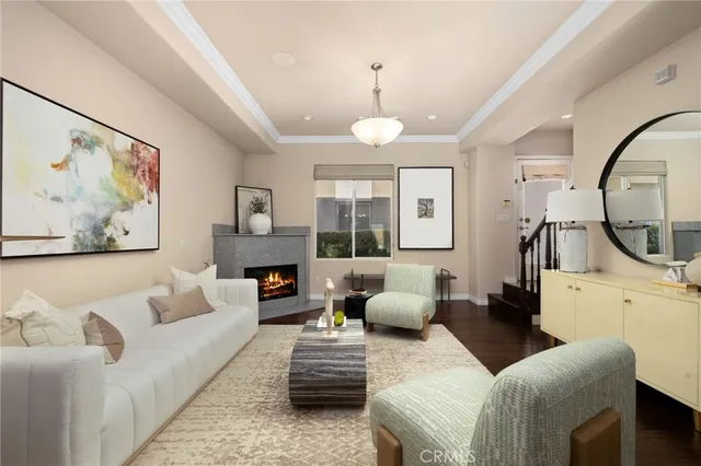 a living room with furniture a large window and a chandelier