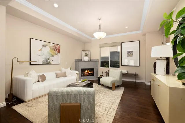 a living room with furniture fireplace and a large window