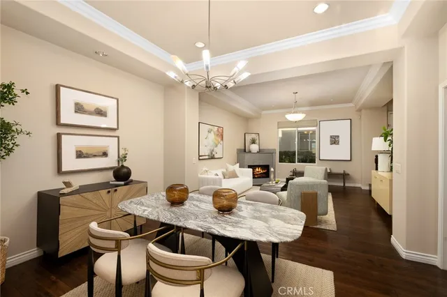 a view of a a dining room with furniture wooden floor and chandelier