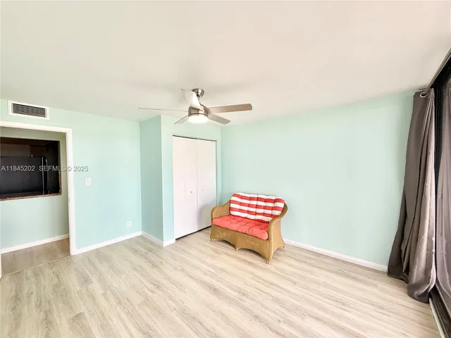 a utility room with sink and mirror