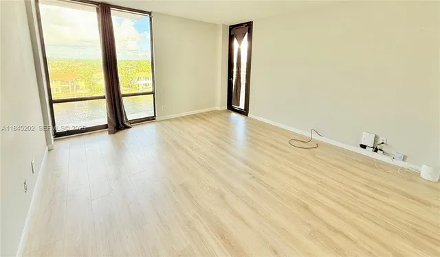 a living room with furniture a chandelier and a window