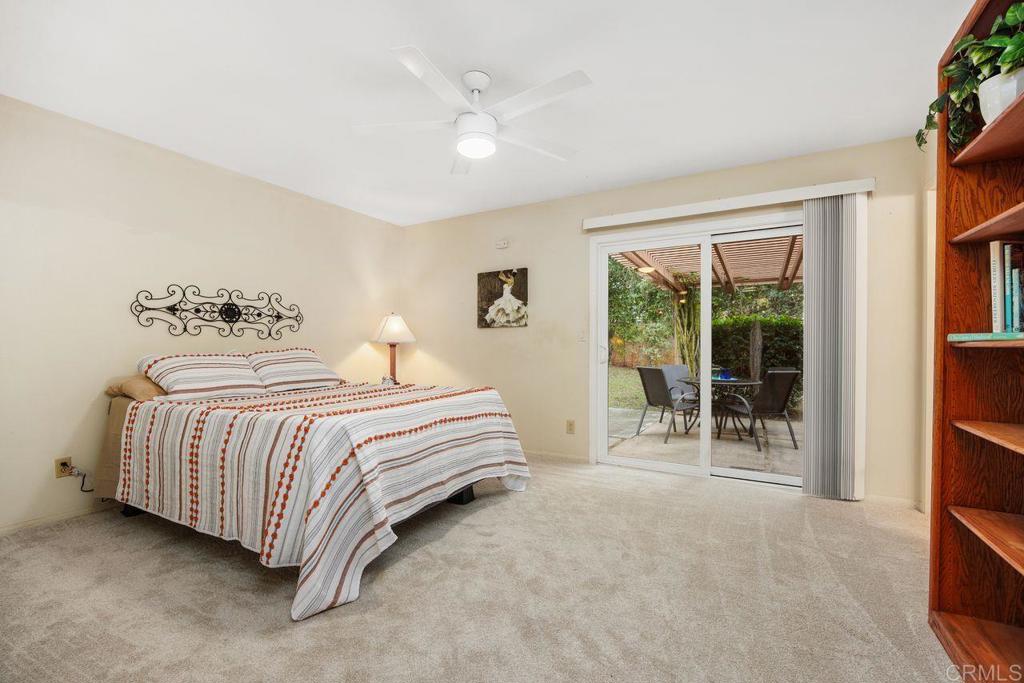 1037 Glenmere Road Vista, CA 92084 - Photo 13 of 36 a bedroom with a bed and a large window with outer view