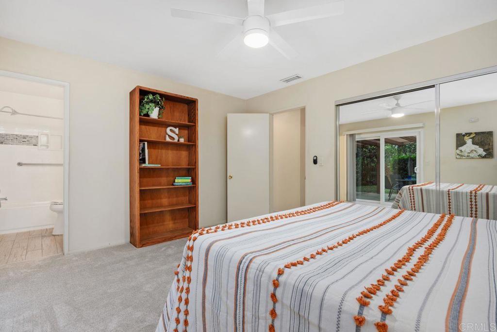 1037 Glenmere Road Vista, CA 92084 - Photo 14 of 36 a bedroom with a bed and a view of closet