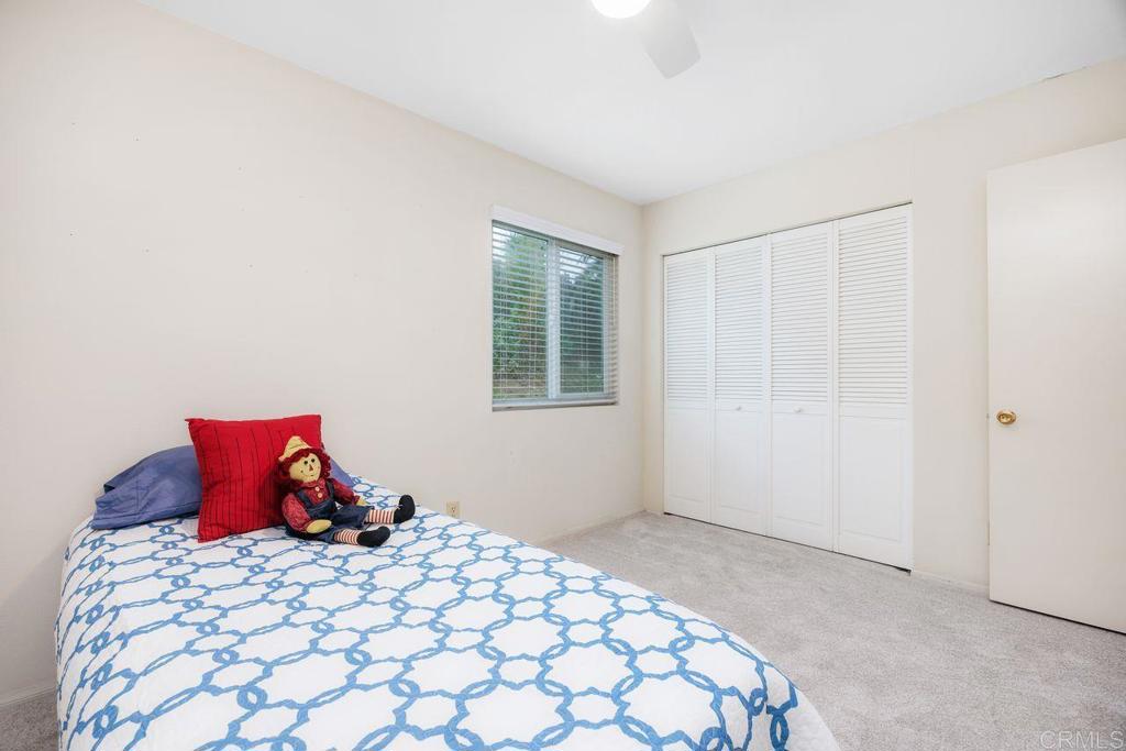 1037 Glenmere Road Vista, CA 92084 - Photo 18 of 36 a bedroom with a bed and a window
