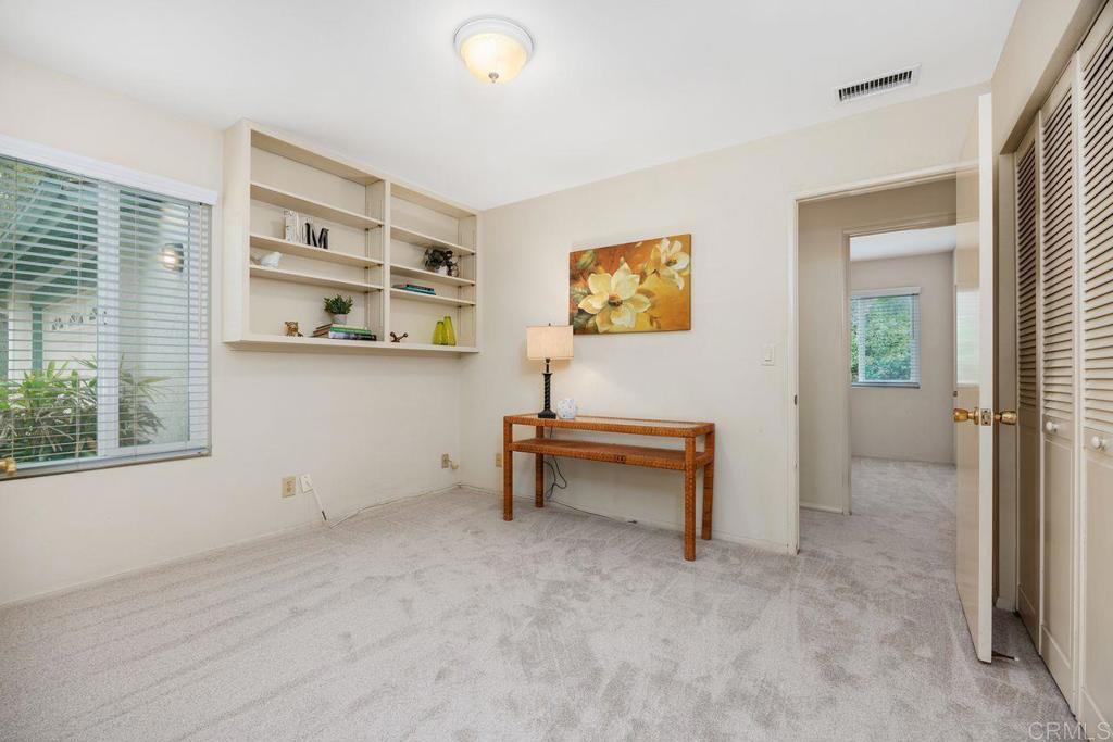 1037 Glenmere Road Vista, CA 92084 - Photo 19 of 36 a view of a workspace with furniture and a window