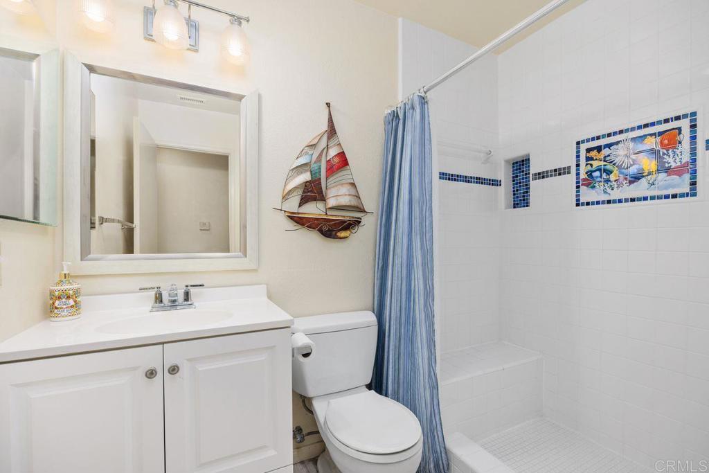 1037 Glenmere Road Vista, CA 92084 - Photo 21 of 36 a bathroom with a sink toilet and a mirror