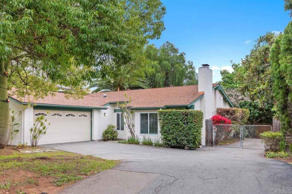 1037 Glenmere Road Vista, CA 92084 - Photo 36 of 36 a front view of a house with a yard and a garage