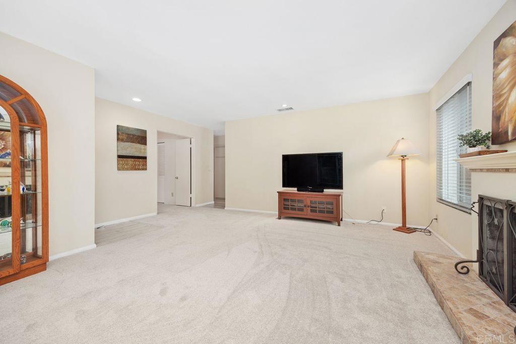 1037 Glenmere Road Vista, CA 92084 - Photo 4 of 36 a view of a livingroom with a flat screen tv and a fireplace