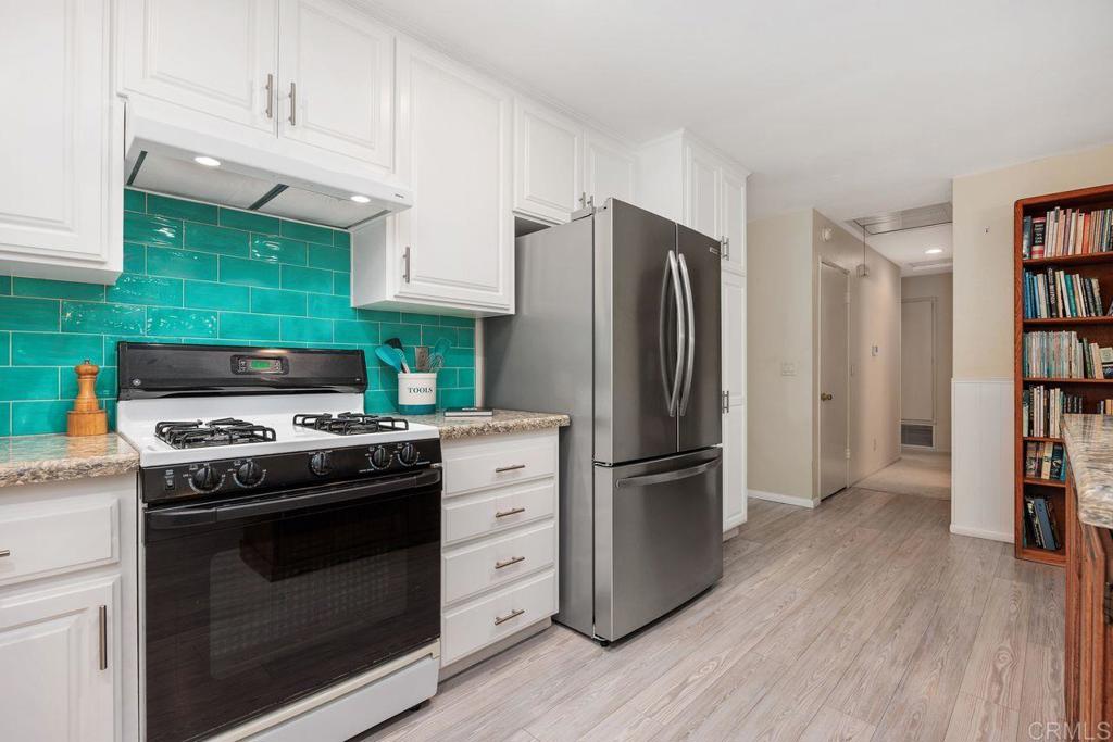 1037 Glenmere Road Vista, CA 92084 - Photo 9 of 36 a kitchen with stainless steel appliances a stove a refrigerator and a cabinets