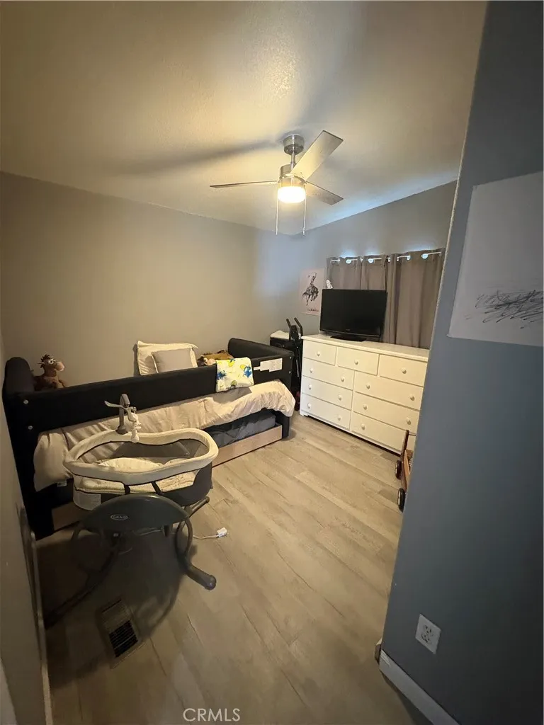 3825 Crestmore Road, Unit 414 Riverside, CA 92501 - Photo 13 of 24 a living room with furniture and a chandelier