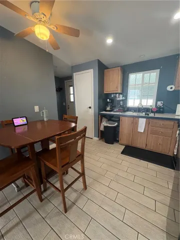 a kitchen with granite countertop a sink a counter top space a stove and cabinets