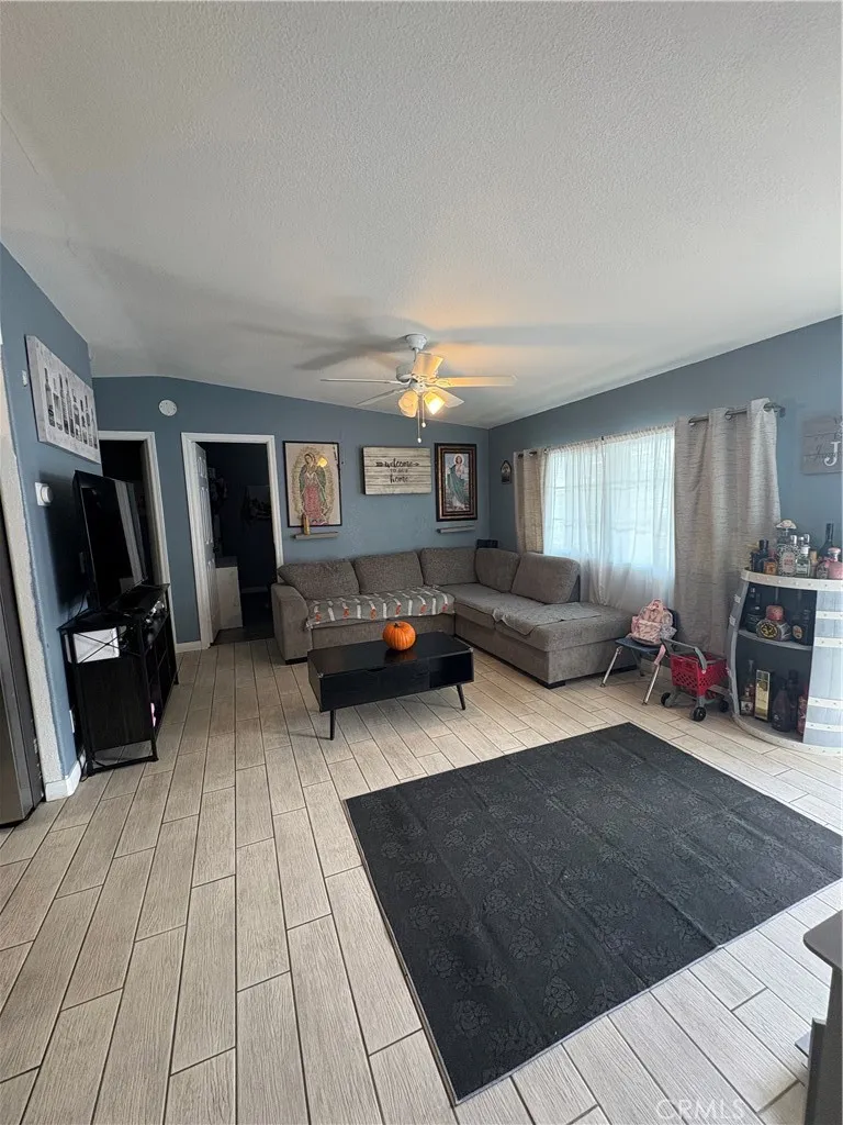 3825 Crestmore Road, Unit 414 Riverside, CA 92501 - Photo 6 of 24 a living room with furniture and a flat screen tv