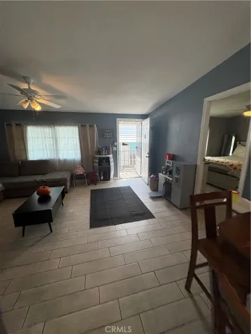 a view of a hallway and a livingroom with furniture