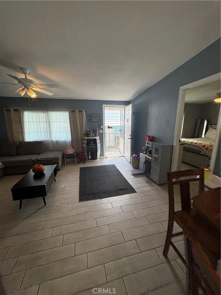 3825 Crestmore Road, Unit 414 Riverside, CA 92501 - Photo 8 of 24 a living room with furniture and a large window