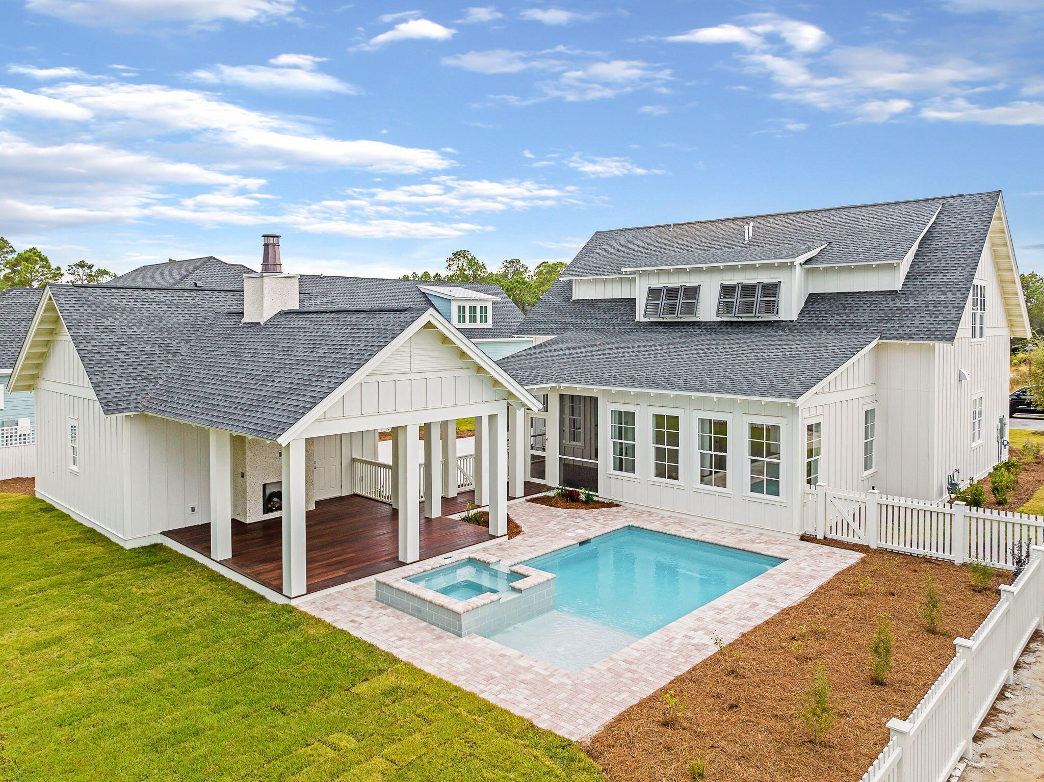 235 Needle Cast Ln Inlet Beach Inlet Beach, FL 32461 - Photo 1 of 58 a view of a white house in front of a big yard plants and large trees