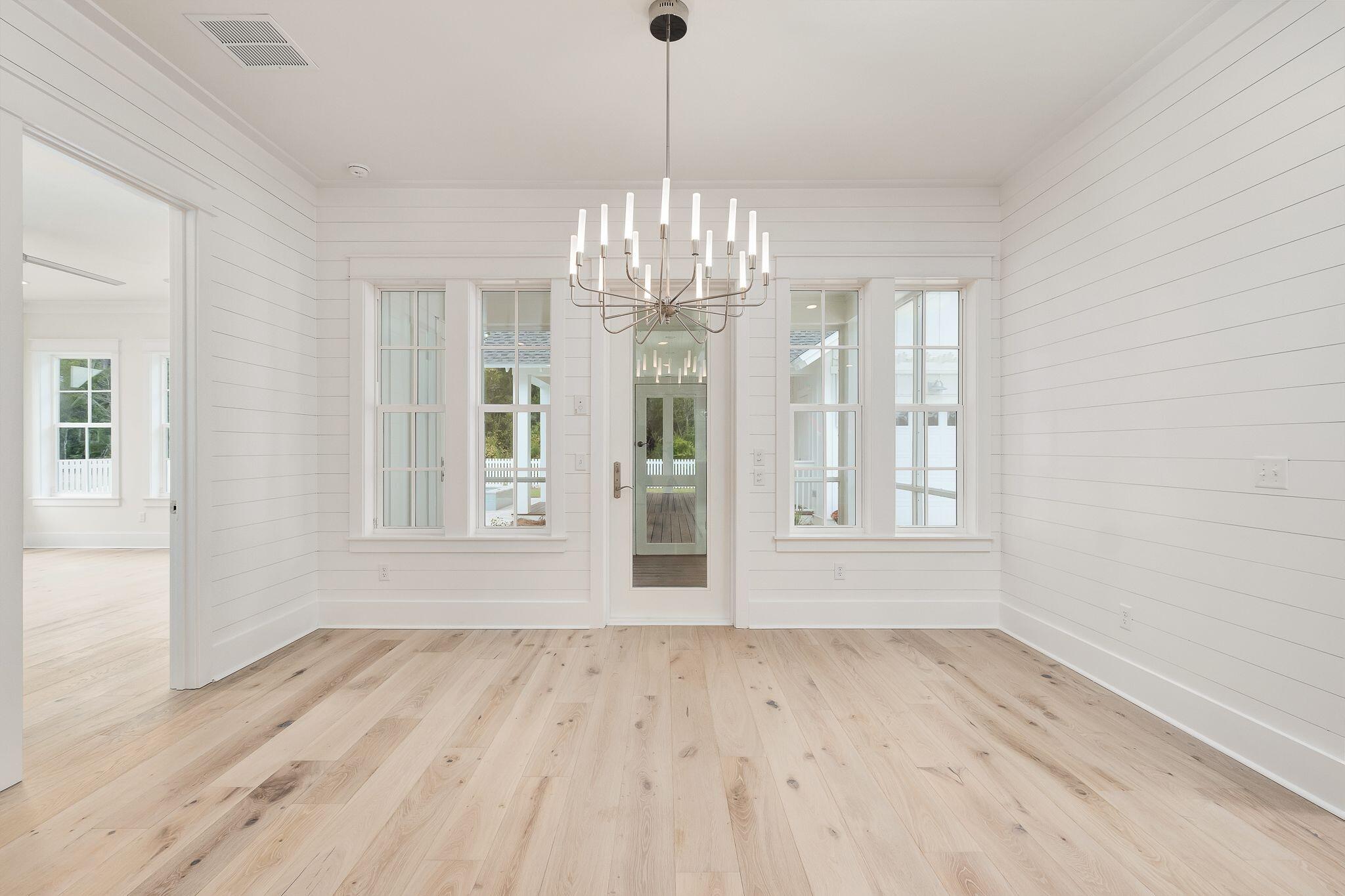 235 Needle Cast Ln Inlet Beach Inlet Beach, FL 32461 - Photo 12 of 58 a view of an empty room with wooden floor and a window