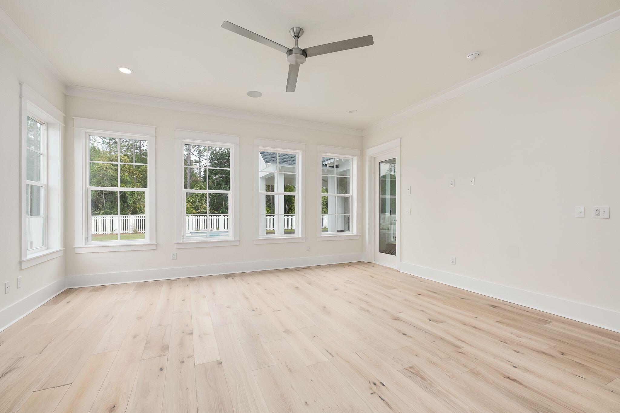 235 Needle Cast Ln Inlet Beach Inlet Beach, FL 32461 - Photo 18 of 58 an empty room with wooden floor and windows