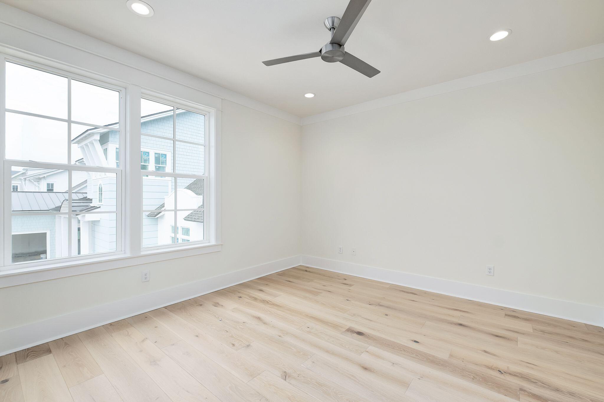 235 Needle Cast Ln Inlet Beach Inlet Beach, FL 32461 - Photo 27 of 58 an empty room with wooden floor and windows