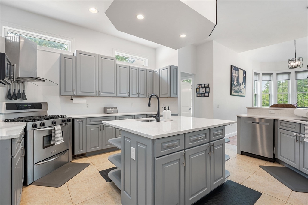 31 Cedar Street North Reading, MA 01864 - Photo 11 of 41 a kitchen with stainless steel appliances granite countertop a sink stove and cabinets