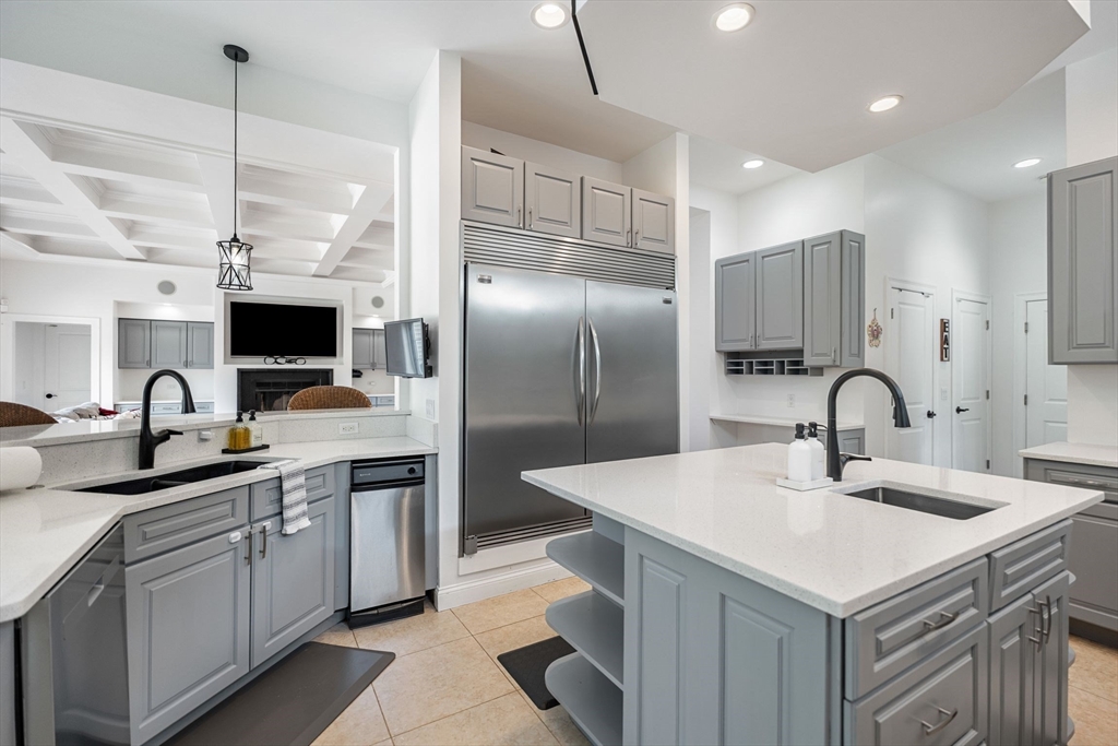 31 Cedar Street North Reading, MA 01864 - Photo 12 of 41 a kitchen with stainless steel appliances a sink dishwasher a refrigerator and a stove with wooden floor
