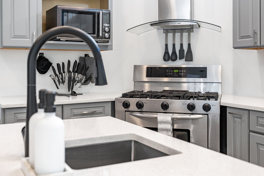 31 Cedar Street North Reading, MA 01864 - Photo 14 of 41 a kitchen with a stove and a sink