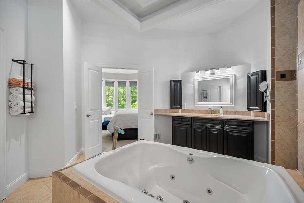 31 Cedar Street North Reading, MA 01864 - Photo 19 of 41 a large white tub sitting in a bathroom