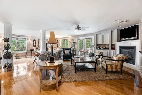a living room with fireplace furniture and a flat screen tv