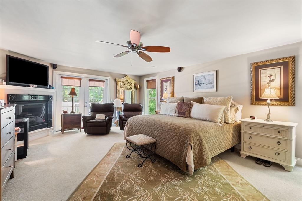 31 Cedar Street North Reading, MA 01864 - Photo 39 of 41 a spacious bedroom with a bed a couch and a flat screen tv