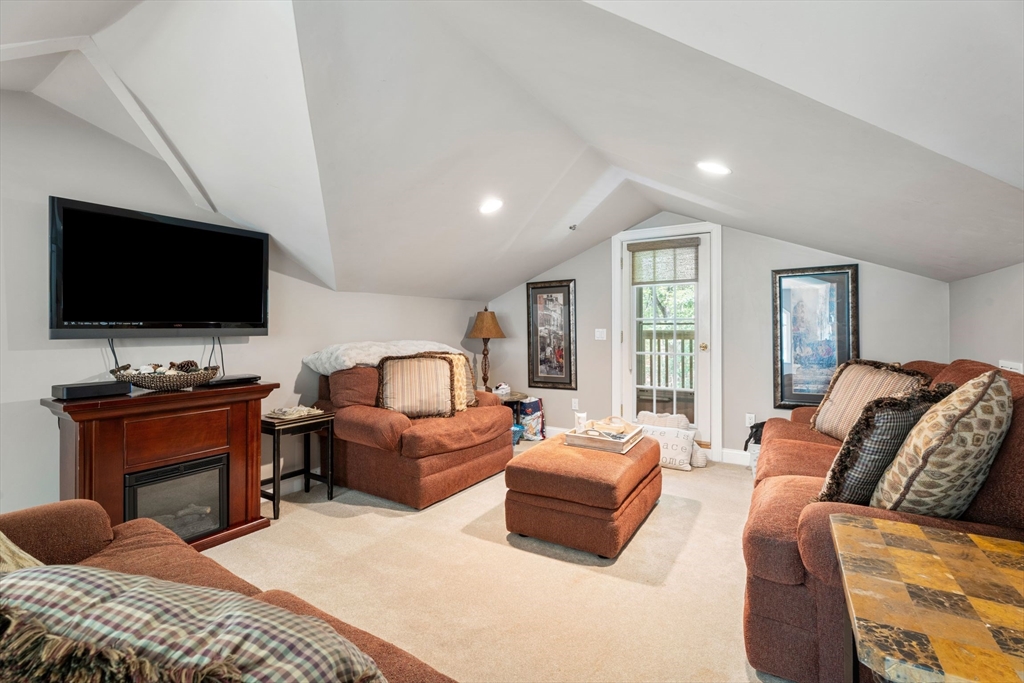 31 Cedar Street North Reading, MA 01864 - Photo 40 of 41 a living room with furniture and a flat screen tv
