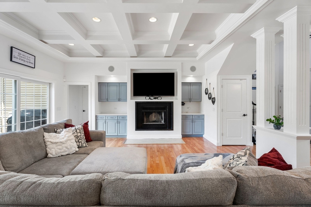 31 Cedar Street North Reading, MA 01864 - Photo 6 of 41 a living room with furniture flat screen tv and a fireplace