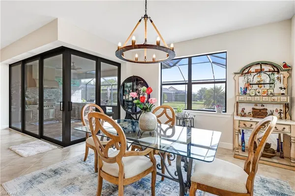 a view of a dining room with furniture wooden floor and a chandelier