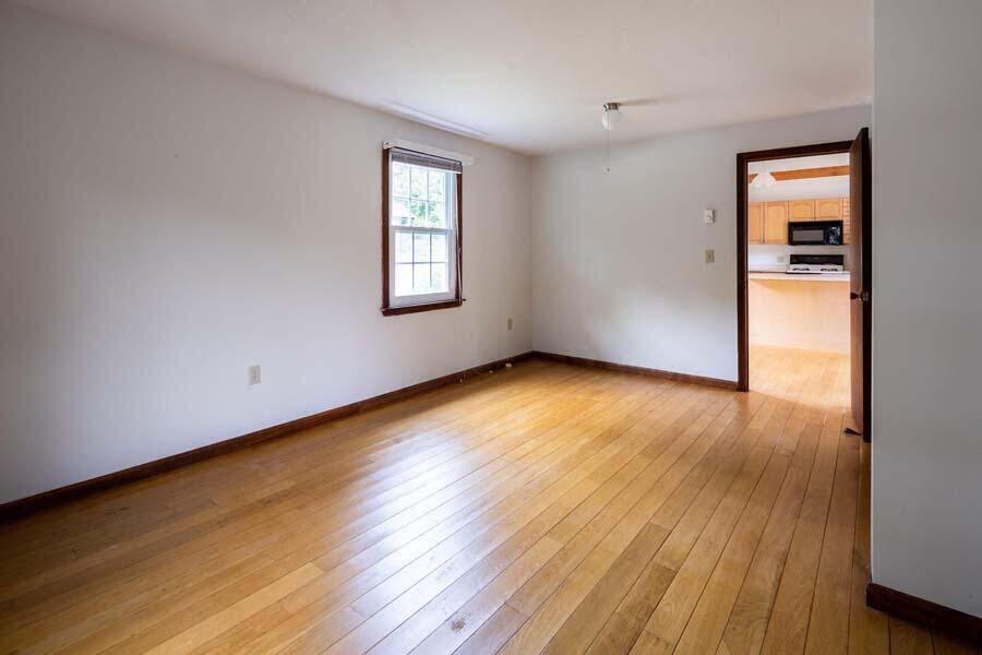 39 Nickerson Road Cotuit, MA 02635 - Photo 12 of 24 wooden floor in an empty room with a window