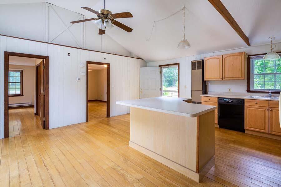 39 Nickerson Road Cotuit, MA 02635 - Photo 7 of 24 a kitchen with stainless steel appliances granite countertop a sink a stove a refrigerator cabinets and wooden floor