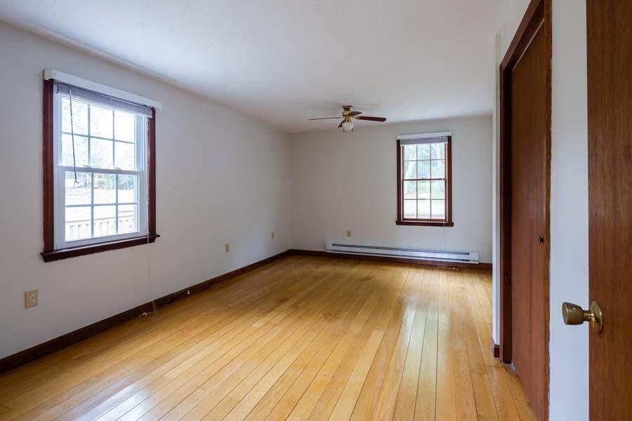 39 Nickerson Road Cotuit, MA 02635 - Photo 9 of 24 a view of an empty room with a window and wooden floor