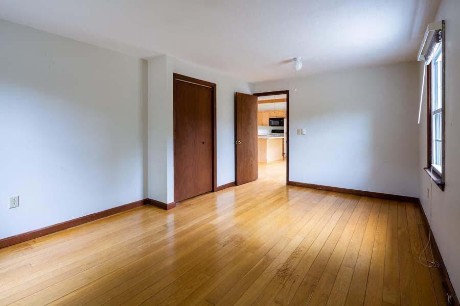 39 Nickerson Road Cotuit, MA 02635 - Photo 10 of 24 a view of an empty room with wooden floor and a window