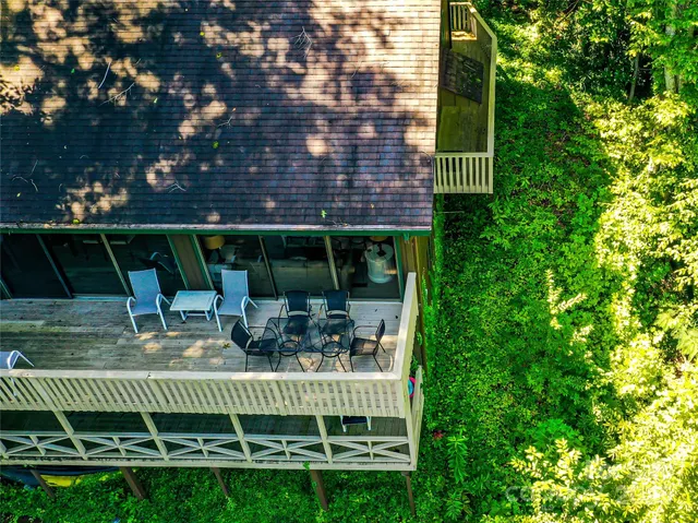 a view of a dining room with furniture water view and a floor to ceiling window