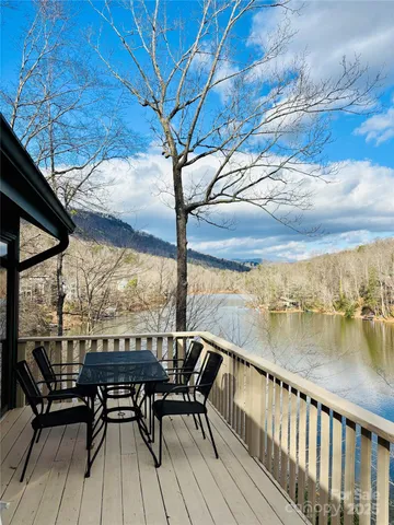 a view of a balcony with mountain view and wooden floor