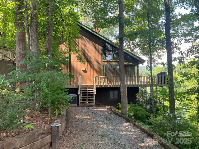 a balcony with wooden floor and lake view
