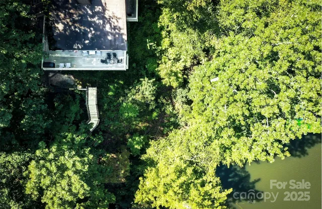 a view of a roof deck with wooden fence and potted plants