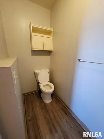 a white toilet sitting next to a small sink