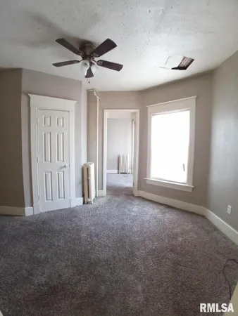a view of empty room with ceiling fan